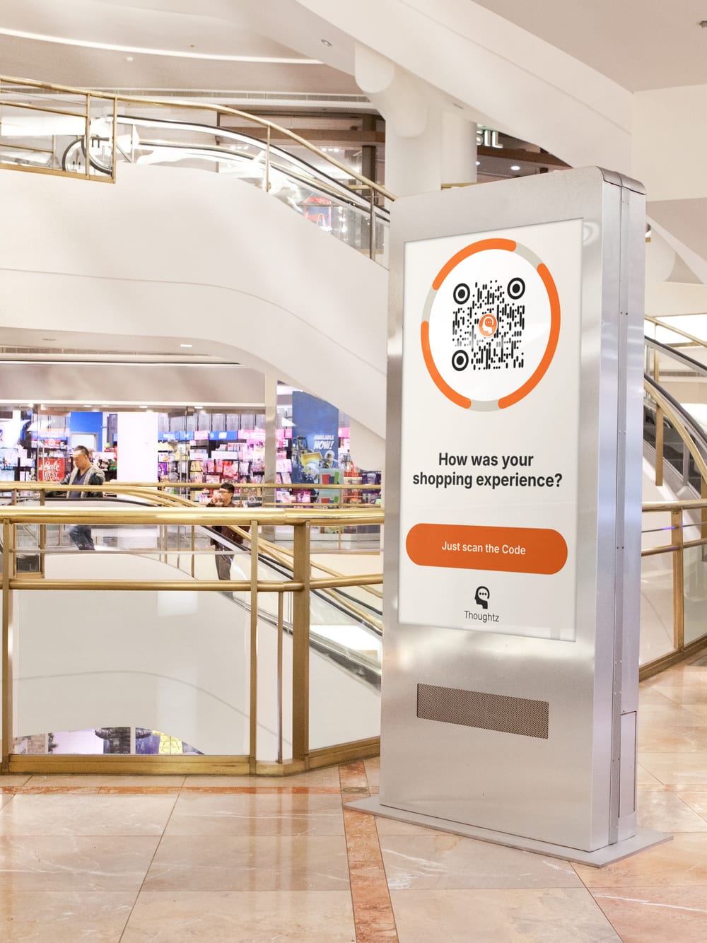 A large digital display in a shopping centre carrying a Thoughtz Code.