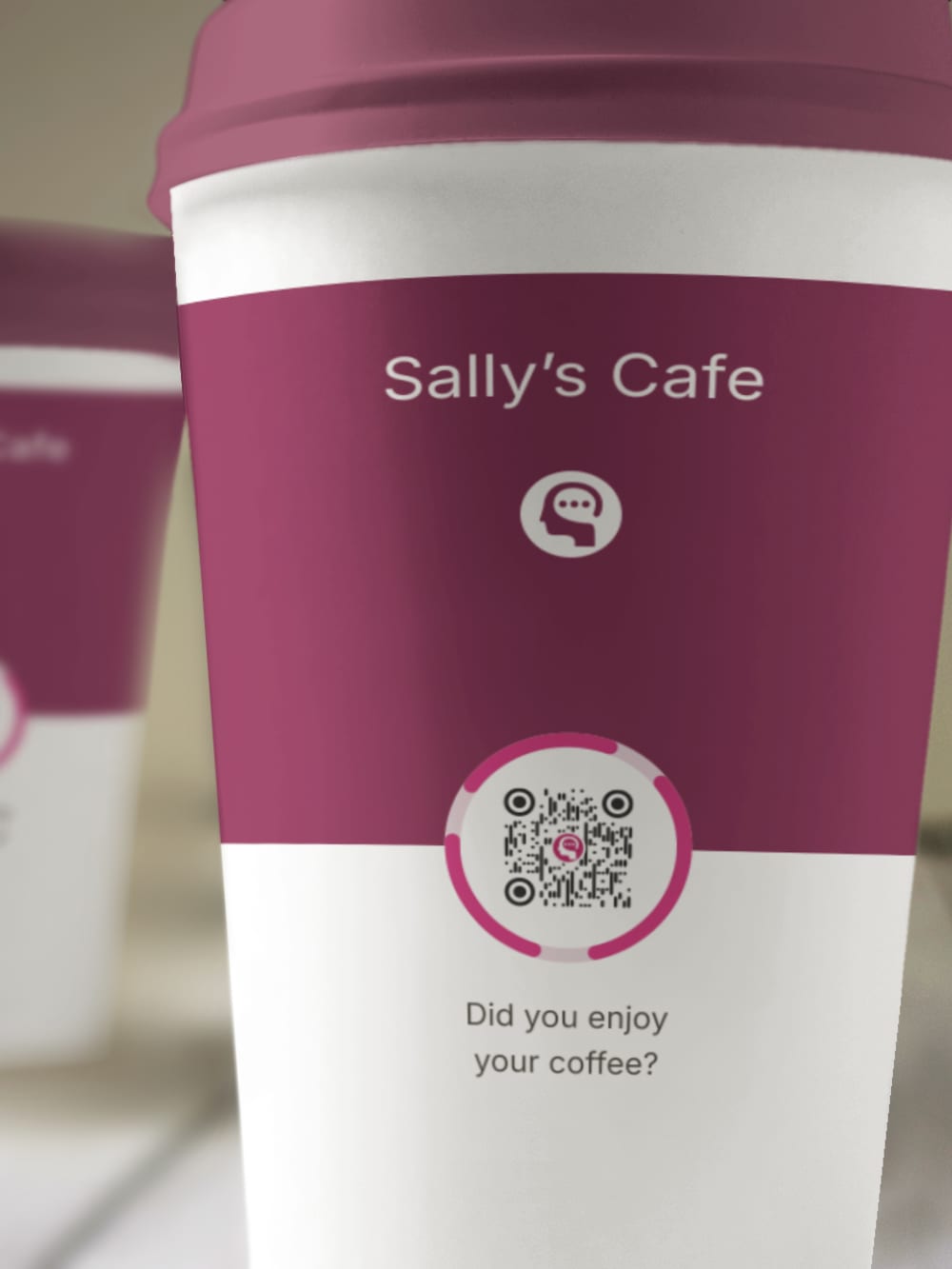 A branded takeaway coffee cup held in one hand, a Thoughtz Code on the side.