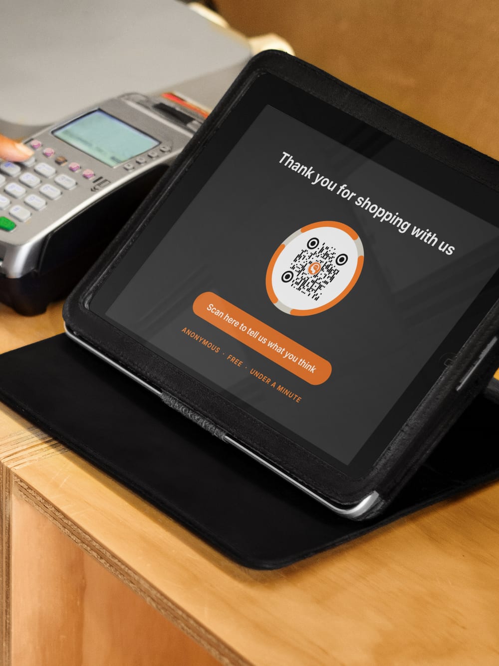 A card terminal at a counter showing a thank-you screen with a Thoughtz Code.